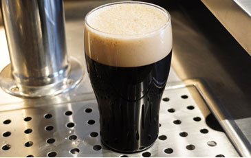 Close-up of a pint glass filled with nitro stout