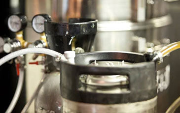 Keg with pressure gauge setup for force carbonating hard seltzer