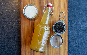 How to Make Boozy Kombucha: Bottle of Kombucha Tea and Ingredients