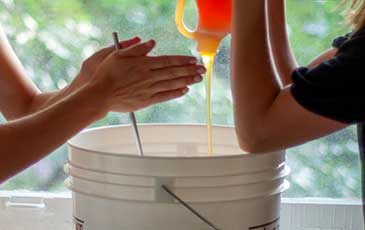 Pouring honey into a bucket for Making Mead