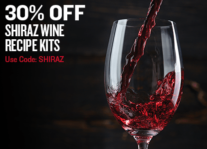 Promotional graphic for Shiraz wine recipe kits showing a large wine glass with red wine being poured into it against a dark background, with text reading '30% OFF SHIRAZ WINE RECIPE KITS' and 'Use Code: SHIRAZ'.