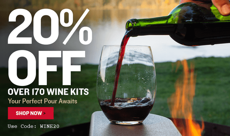 Person pouring red wine into a glass with a scenic background, promotional text overlay for wine kits sale. 20% off over 170 Wine Kits. Use code: WINE20