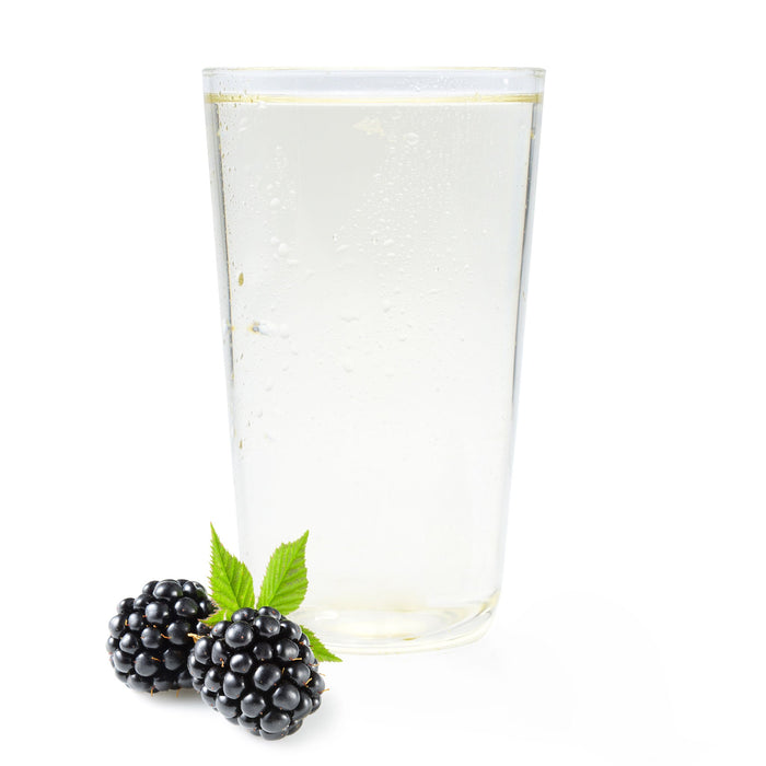 Glass of sparkling blackberry Ranch Water with fresh blackberries and green leaves on white background.