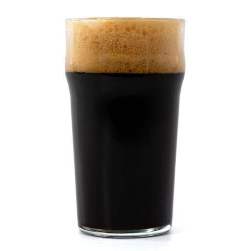 Glass of dark beer with a thick head on a white background