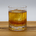 High Rye Bourbon Whiskey in a glass with ice on a wood table.