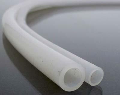 Two tube lines resting next to each other, the one of the left has thicker tubing than the right.