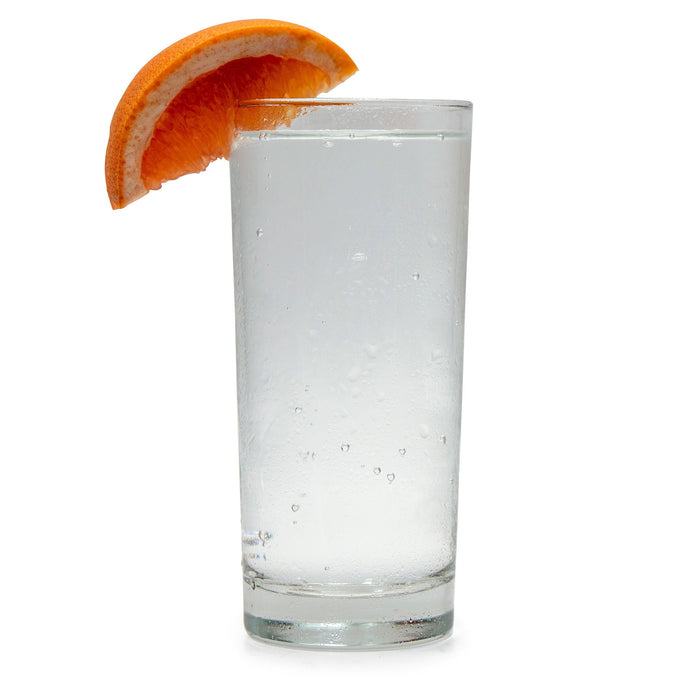 A grapefruit-wedged glass filled with Ruby Grapefruit Hard Seltzer