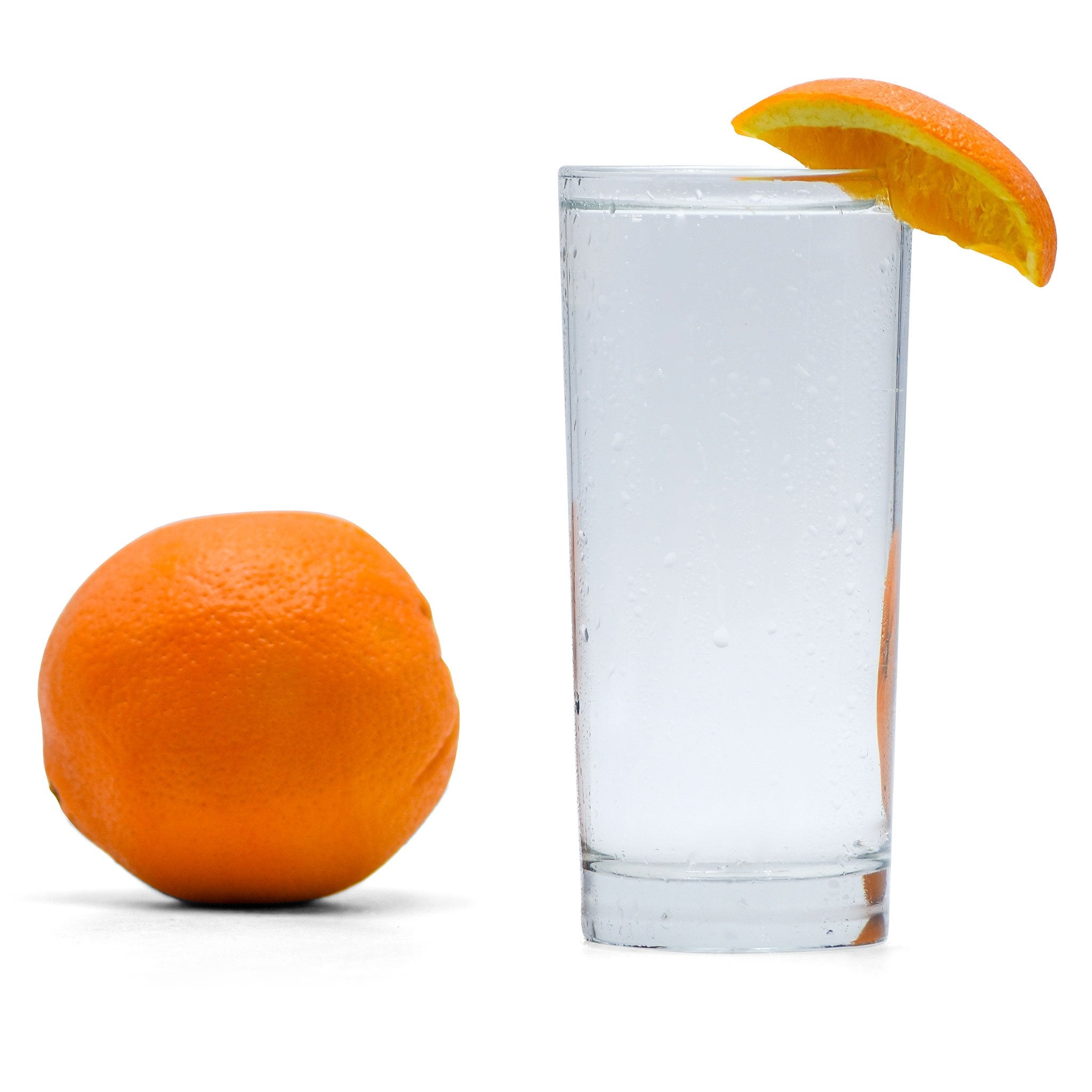 A glass full of Navel Orange Hard Seltzer with an orange wedge next to the glass.