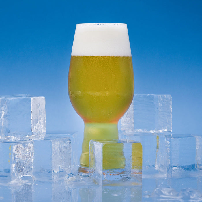 Chill Factor Cold IPA in a glass with ice cubes around it. 