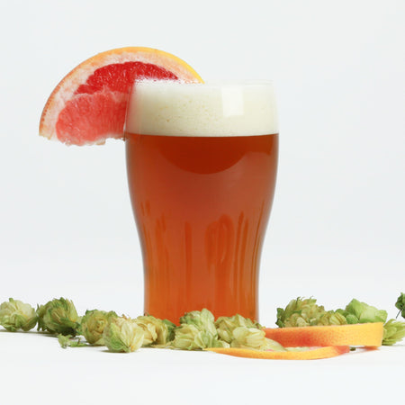 Fresh Squished IPA with a grapefruit wedge amidst hop cones