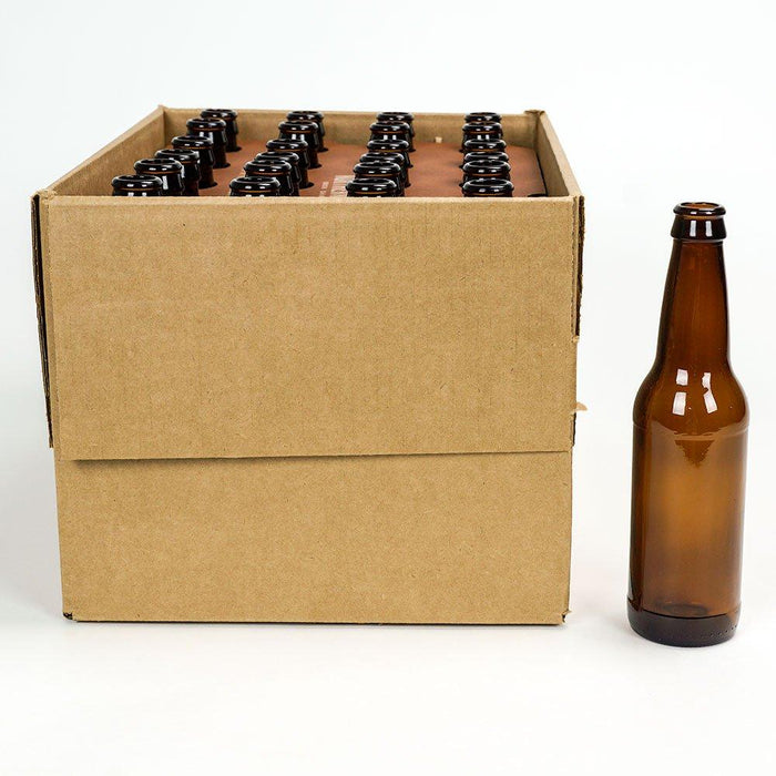 An open box of 24 beer bottles, and a brown glass bottle standing next to it.