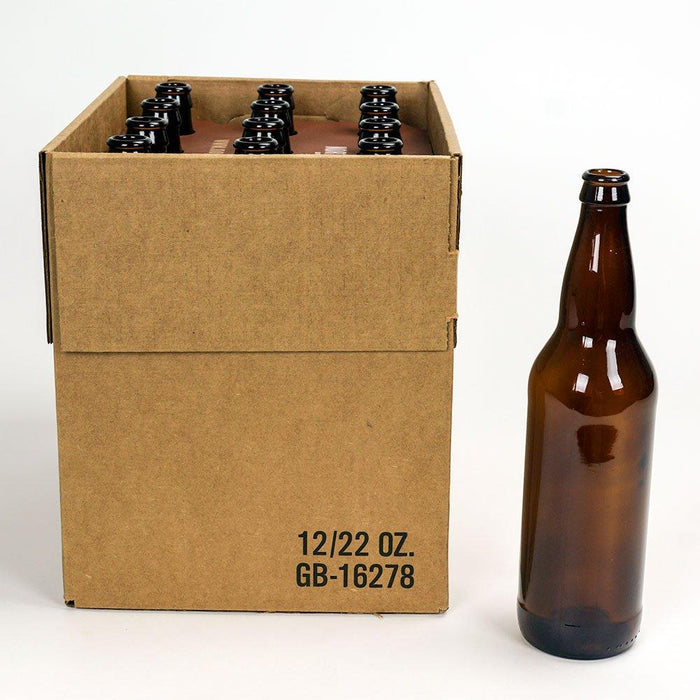 A 22 ounce brown beer bottle standing next to a 12 pack of beer bottles.